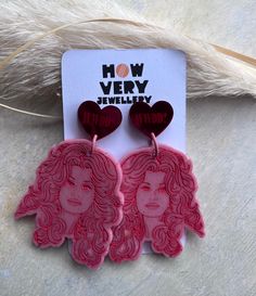 Super shiny red mirror heart stud earrings with WWDD? engraved inside with pink steel jump rings attached to Dolly portraits. Fun and feisty, these earrings are an awesome gift to anyone that loves the Queen of Country music herself 💗 Super lightweight acrylic hearts set on nickel-free stainless steel posts.  They measure approx 1.7cm/17mm, the total drop of these are approx 6cm. Hand made in small batches in beautiful North Norfolk. About the materials used: *All of your jewellery starts out as a blank and empty mould cavity, the mixing, pouring, sinking, flower pressing, glitter mixing, setting and remoulding process is a slow and careful labour of love resulting in beautifully lightweight, environmentally responsible pieces that will last years if you look after them.  *Each piece vari North Norfolk, Flower Pressing, Gift For Bestie, Red Mirror, Heart Stud Earrings, Handmade Charms, Music Fans, Dolly Parton, Heart Studs