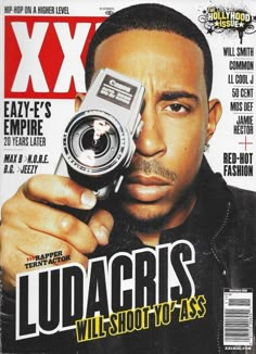 a man holding a camera on the cover of xx magazine, which features ludacris