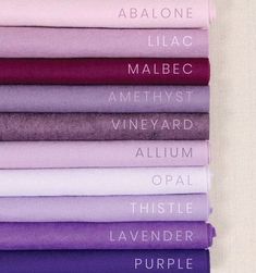 purple and white sheets are stacked on top of each other, with the words above them