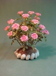 pink roses and white eggs in a vase