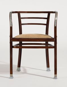 a wooden chair with a woven seat and metal frame, viewed from the front side