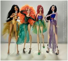 four barbie dolls are standing next to each other in dresses and high heeled shoes