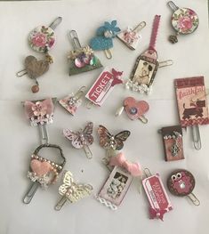 there are many different types of hair clips on the table with tags and brooches