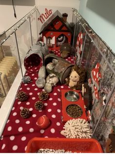 there are many items on the table with red and white polka dot cloth, including pine cones