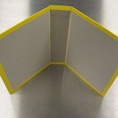 an open yellow and white box on top of a metal surface with the lid closed