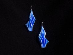 pair of blue earrings on black background