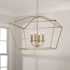 a chandelier hanging from the ceiling in a room with white walls and windows