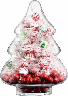 a christmas tree made out of candy balls and wrapped in plastic wrap on top of a clear platter