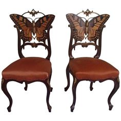 two chairs with butterfly wings on them, one is red and the other is brown