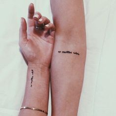 two people with matching tattoos on their arms