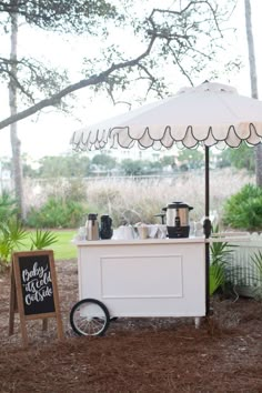 a small ice cream cart under an umbrella