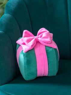 a green chair with a pink bow on it