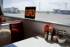 a sign that reads stop on the side of a bus window next to some condiments