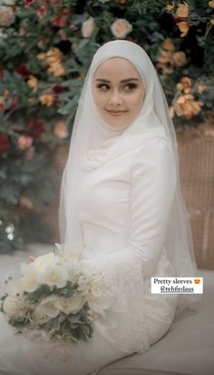 a woman wearing a veil and holding a bouquet