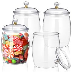 three glass jars with lids and handles filled with candy