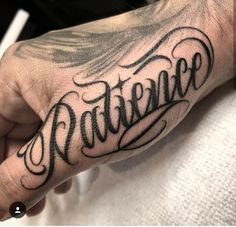 a person with a tattoo on their hand and the word baltimore written in cursive writing