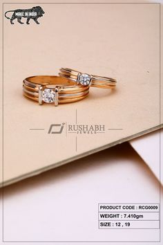 two gold wedding rings with diamonds on top of each other in front of a beige background