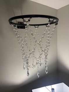 a chandelier hanging from the ceiling in a room with white walls and flooring