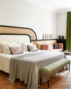 a bedroom with a large bed and green curtains