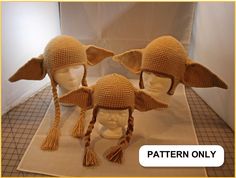 three crocheted hats with braids and ears on display