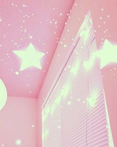 a bedroom with pink walls and stars painted on the ceiling, along with white blinds