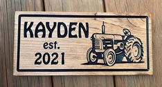 a wooden sign with a tractor on it