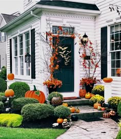 a house decorated for halloween with pumpkins and other decorations