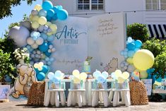 an outdoor birthday party with balloons and winnie the pooh decorations