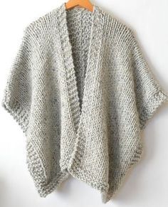 a gray sweater hanging on a wooden hanger