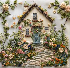 an image of a house made out of flowers and plants on the side of a wall