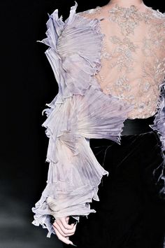 the back of a woman's dress with ruffled sleeves