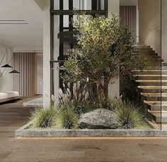 a living room filled with lots of furniture and plants in front of a stair case