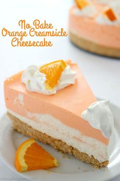 a slice of orange cheesecake on a white plate with an orange wedge next to it