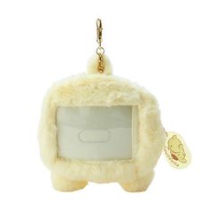 a stuffed animal keychain hanging from a chain with a small white object in the middle