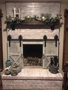 the fireplace is decorated with flowers and greenery