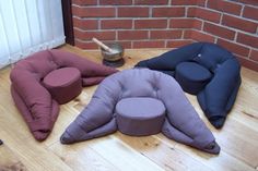 four different colored cushions sitting on the floor