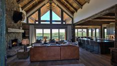 a living room filled with lots of furniture and a fire place in the middle of it