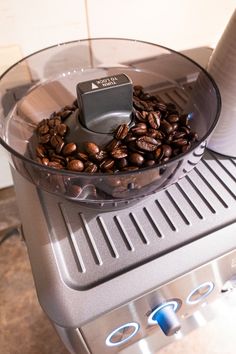 a coffee grinder filled with lots of coffee beans