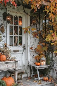 a porch with pumpkins and candles on it