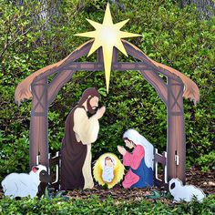 a nativity scene with the birth of jesus and three wise men, surrounded by greenery