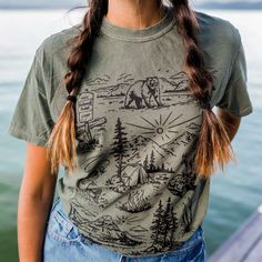 Our newest design for spring! We are so ready to explore the national forests this summer!! Unisex tee - model is wearing a medium Body Length 28 29 30 31 32 Chest Width (Laid Flat) 18 20 22 24 26 A Montana Scene Original Design. Printed in Montana. All designs are property of The Montana Scene. All rights reserved. All of The Montana Scene apparel is designed and printed locally in Montana. Come visit our storefront locations! Bigfork * Whitefish * Missoula * Kalispell * Bozeman Casual Relaxed Fit T-shirt For Outdoor Activities, Summer Short Sleeve T-shirt For Outdoor Activities, Summer Camping T-shirt With Crew Neck, Casual T-shirt For Outdoor Summer Activities, Casual Summer T-shirt For Outdoor, Summer Graphic Print Tops For Outdoor, Spring Outdoor Crew Neck T-shirt, Summer Outdoor Cotton T-shirt, Casual T-shirt For Outdoor Spring Activities