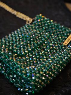 Experience the Luxury of Handmade Artistry with Lively Trends 🌟 Transform your style with our exquisite Emerald Green Crystal Beaded Bag, a masterpiece by Cloud Market Limited under the "Lively Trends" brand. This stunning bag, featuring three tones of shimmering crystals, is designed to add a touch of glamour and sophistication to any outfit. 👝 Bag Features: Dazzling Design: Our emerald green bag is adorned with three tones of shiny crystals, creating a captivating sparkle that will turn head Cheap Green Beaded Shoulder Bag, Shiny Crystals, Emerald Green Crystal, Bridal Bag, Crystal Clutch, Beaded Handbag, Beaded Bag, Wedding Bag, Shoulder Chain