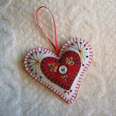 an ornament shaped like a heart on a white surface