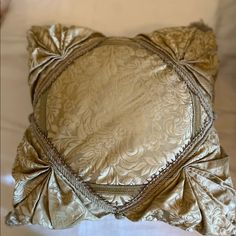 a gold pillow with an intricate design on it