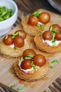 small food items sitting on top of a wooden cutting board