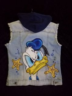 a denim vest with an image of a cartoon character holding a starfish on it