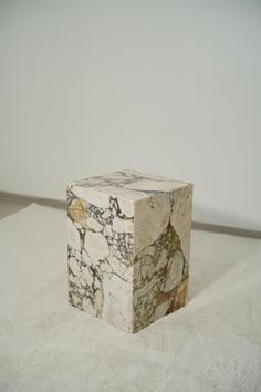 a marble block sitting on top of a white rug