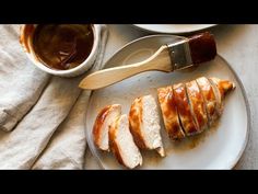 slices of sliced chicken on a plate with sauces and a spatula next to it