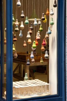 a window with many different colored lights hanging from it