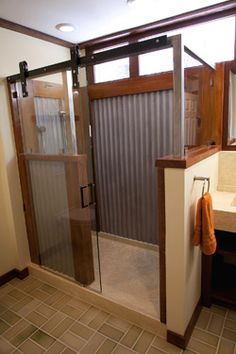 a bathroom with a walk in shower next to a sink